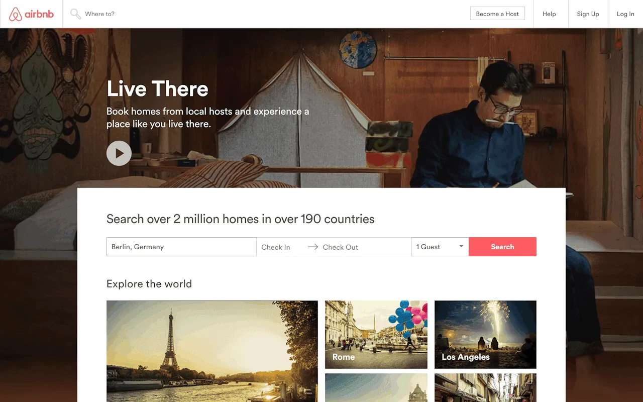 Airbnb website header featuring large universal search bar with location, dates, and guests, plus simple utility icons.